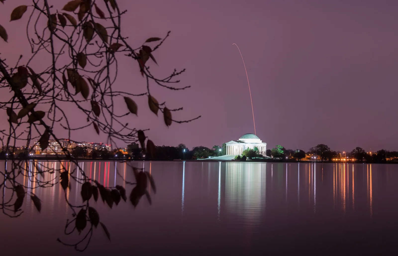 A night launch seen across open water.