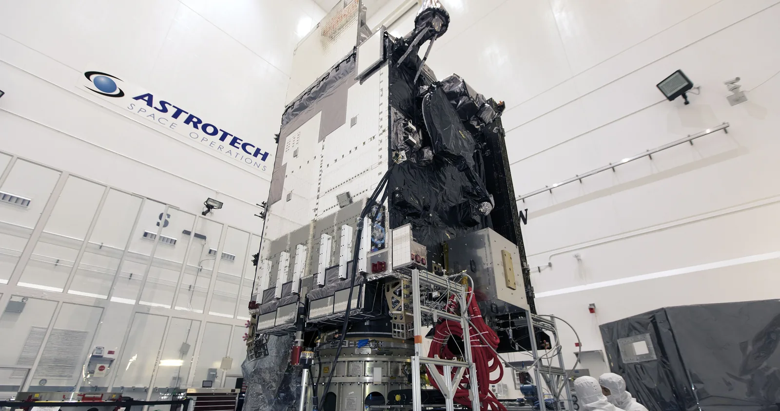 A spacecraft on its stand in a clean room.